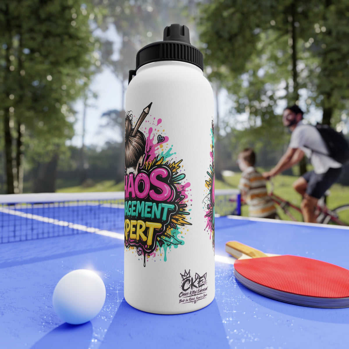 a white bottle with a black cap and a ball on a blue table with a ping pong racket and a man riding a bicycle