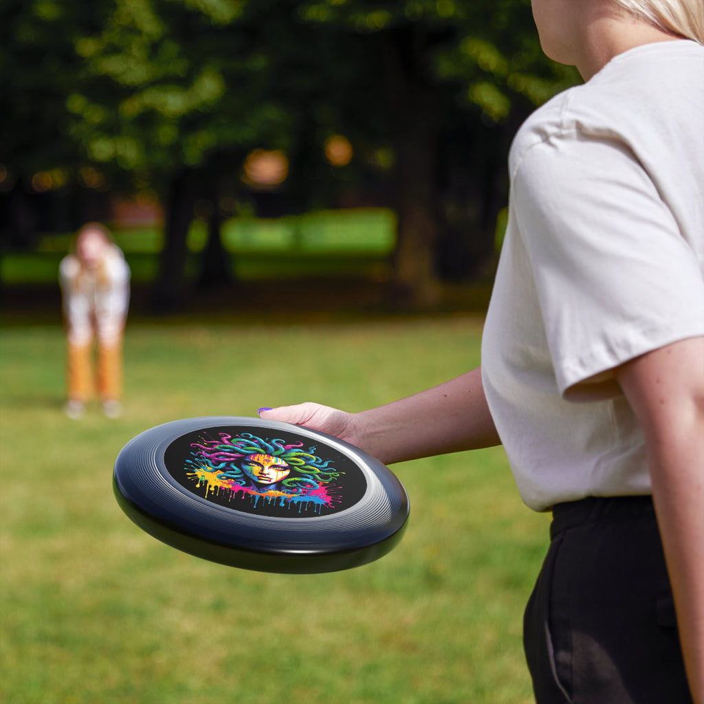 Colorful Medusa flying disc held outdoors, showcasing its vibrant graffiti-inspired design. Perfect for outdoor fun.