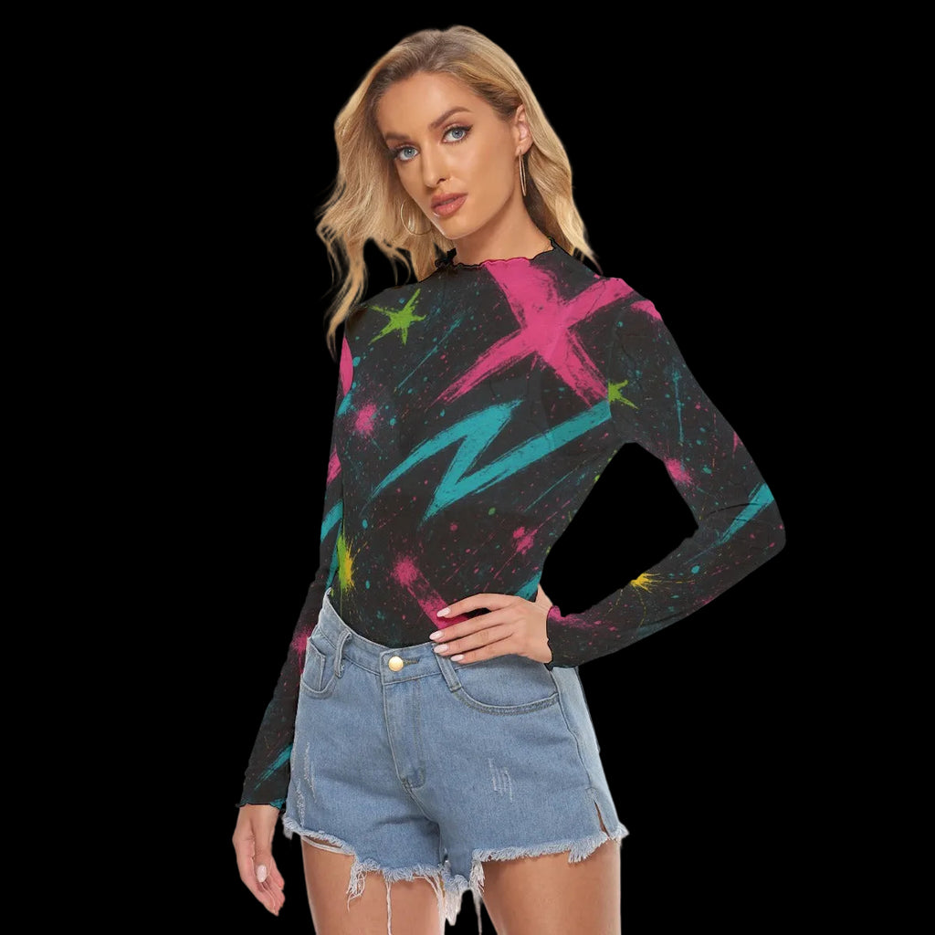 Woman wearing a fitted long-sleeve top with vibrant graffiti print, paired with denim shorts for a casual look.