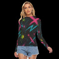 Long-sleeve top with vibrant abstract graffiti print in cyan, magenta, and lime on a black background, styled with denim shorts.