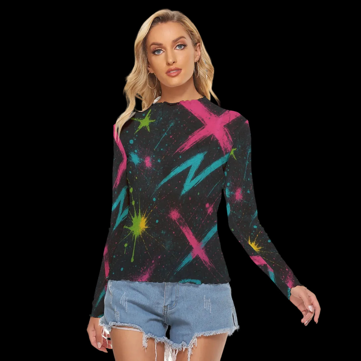 Long-sleeve top with vibrant abstract graffiti print in cyan, magenta, and lime on a black background, styled with denim shorts.