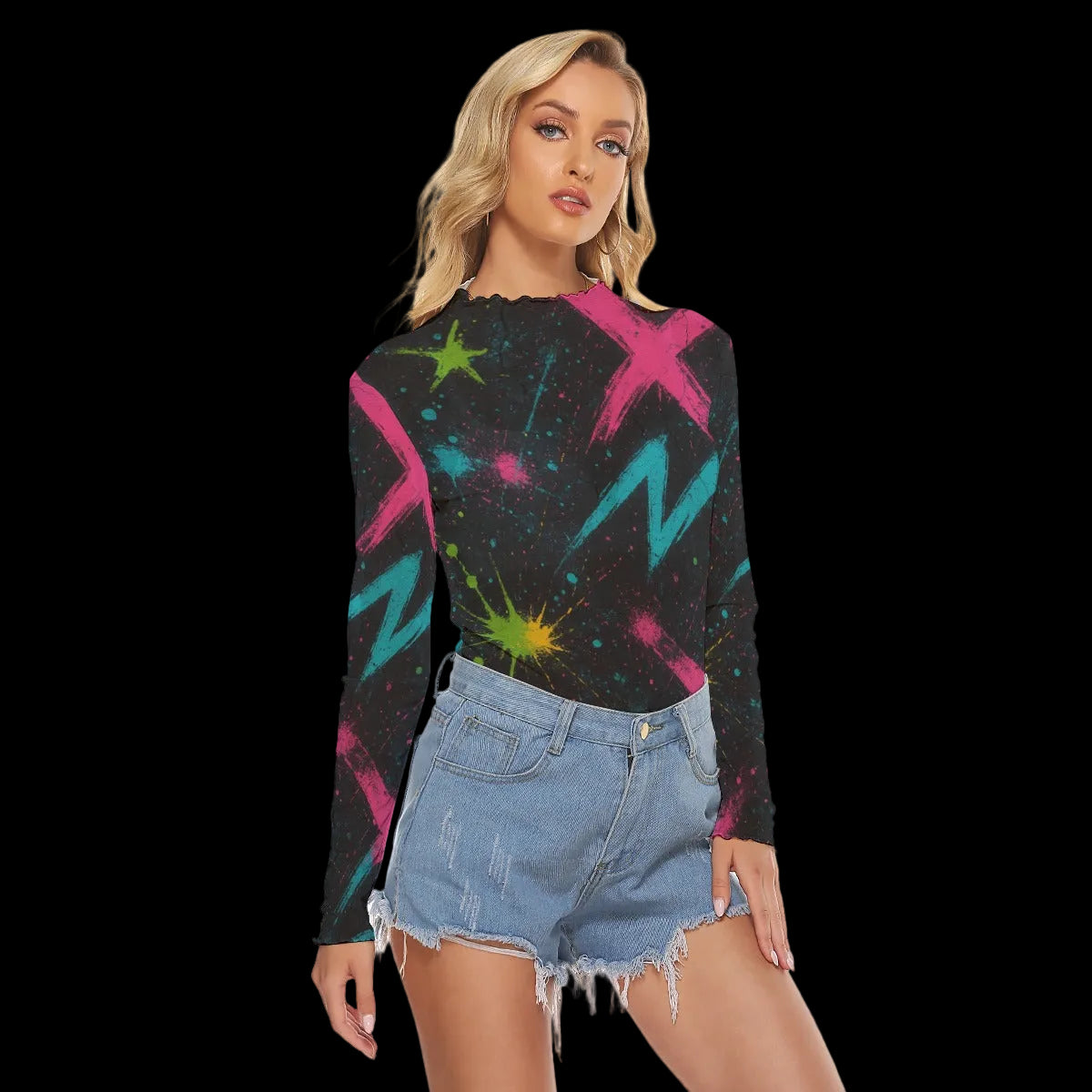Woman wearing a black long-sleeve top with colorful abstract designs and denim shorts on a white background