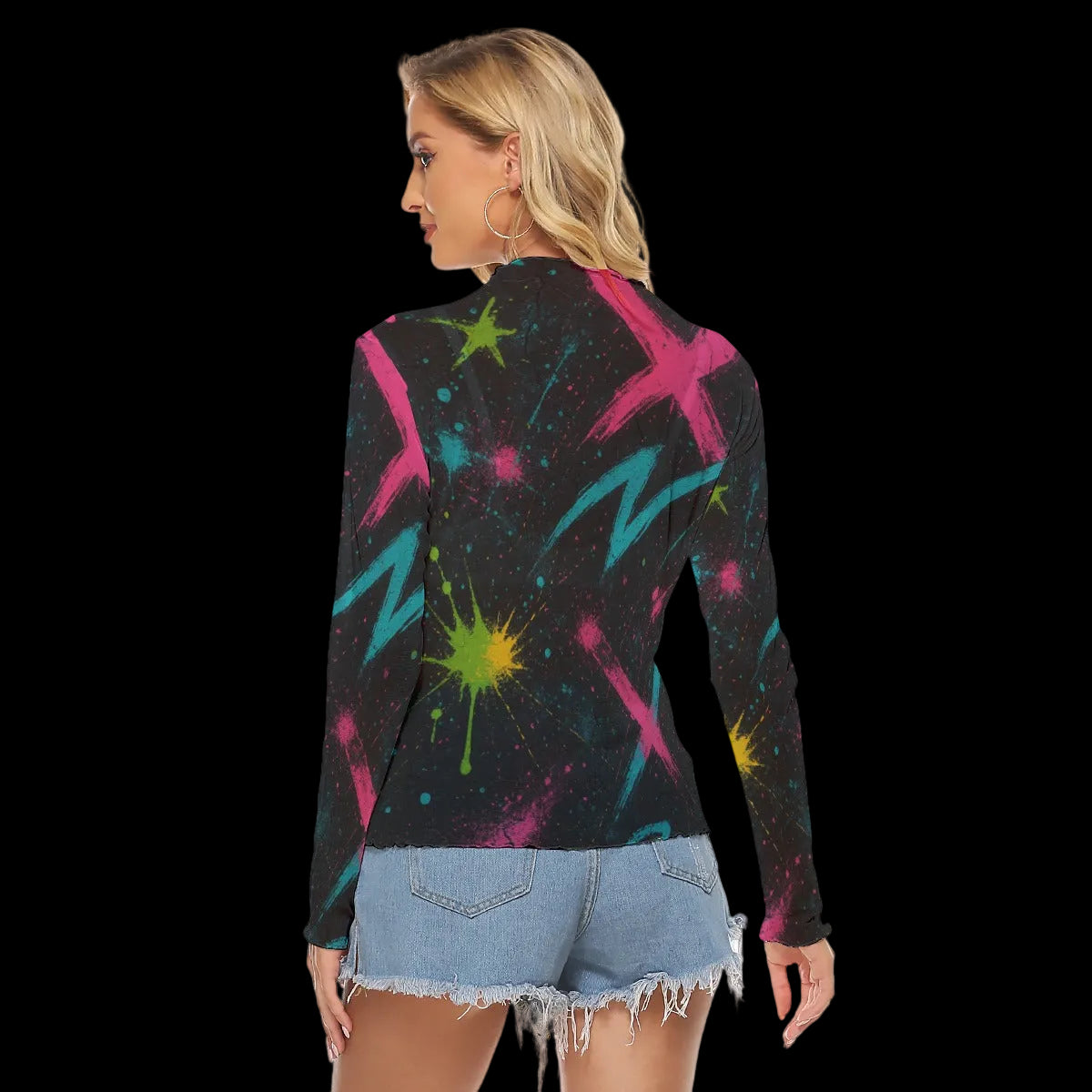 Bold abstract graffiti print long-sleeve top in vibrant colors, styled with denim shorts for an edgy look.
